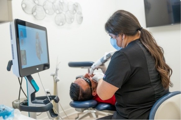 Dental team member using digital impression system