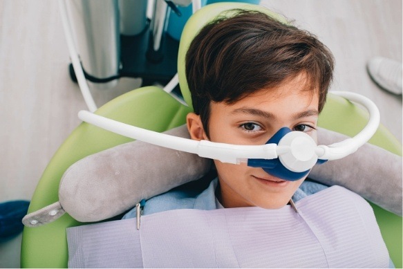 Child receiving nitrous oxide sedation dentistry for kids