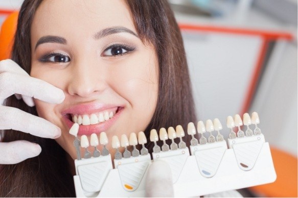 Smile compared to veneers color options during cosmetic dentistry visit